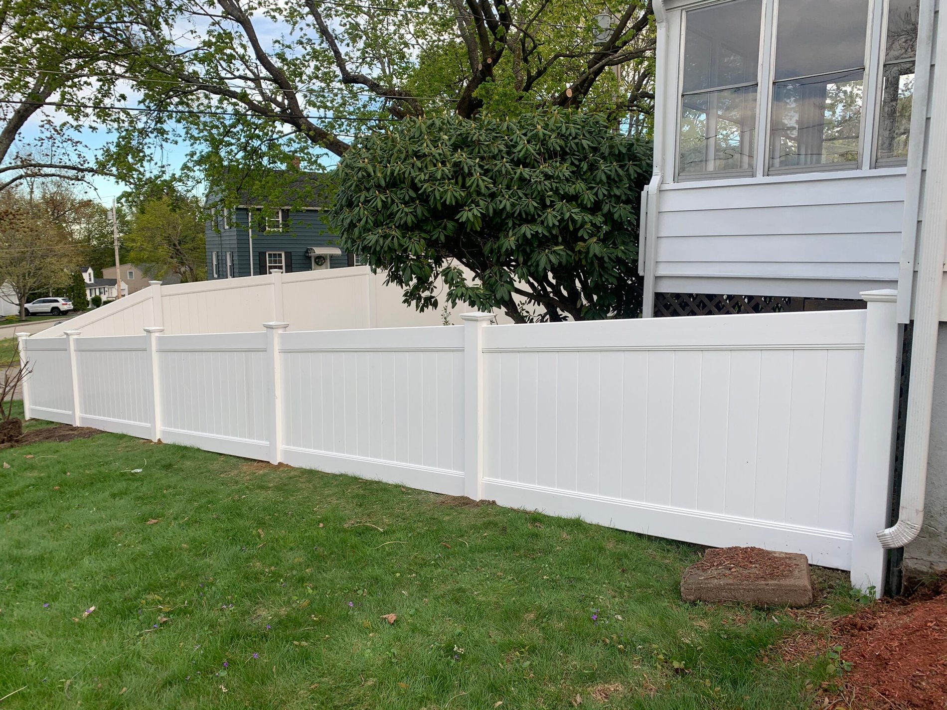 White vinyl privacy fence installed along a Worcester back yard by Prime Fence
